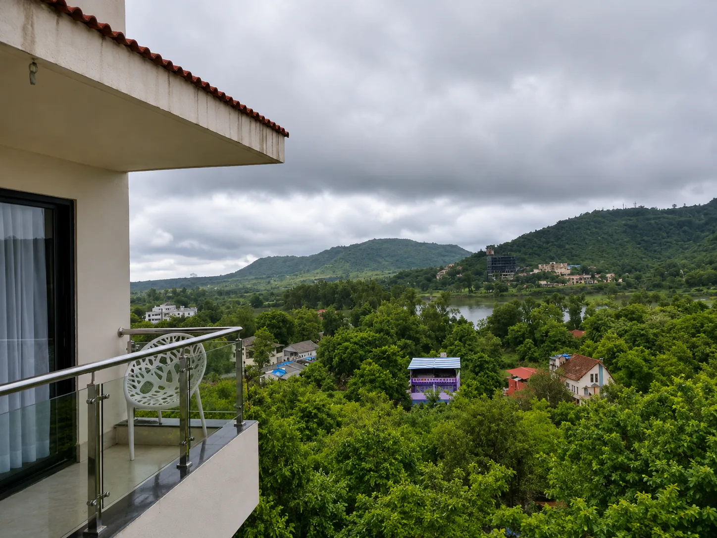Green hill view from a Toran Hill Resort balcony