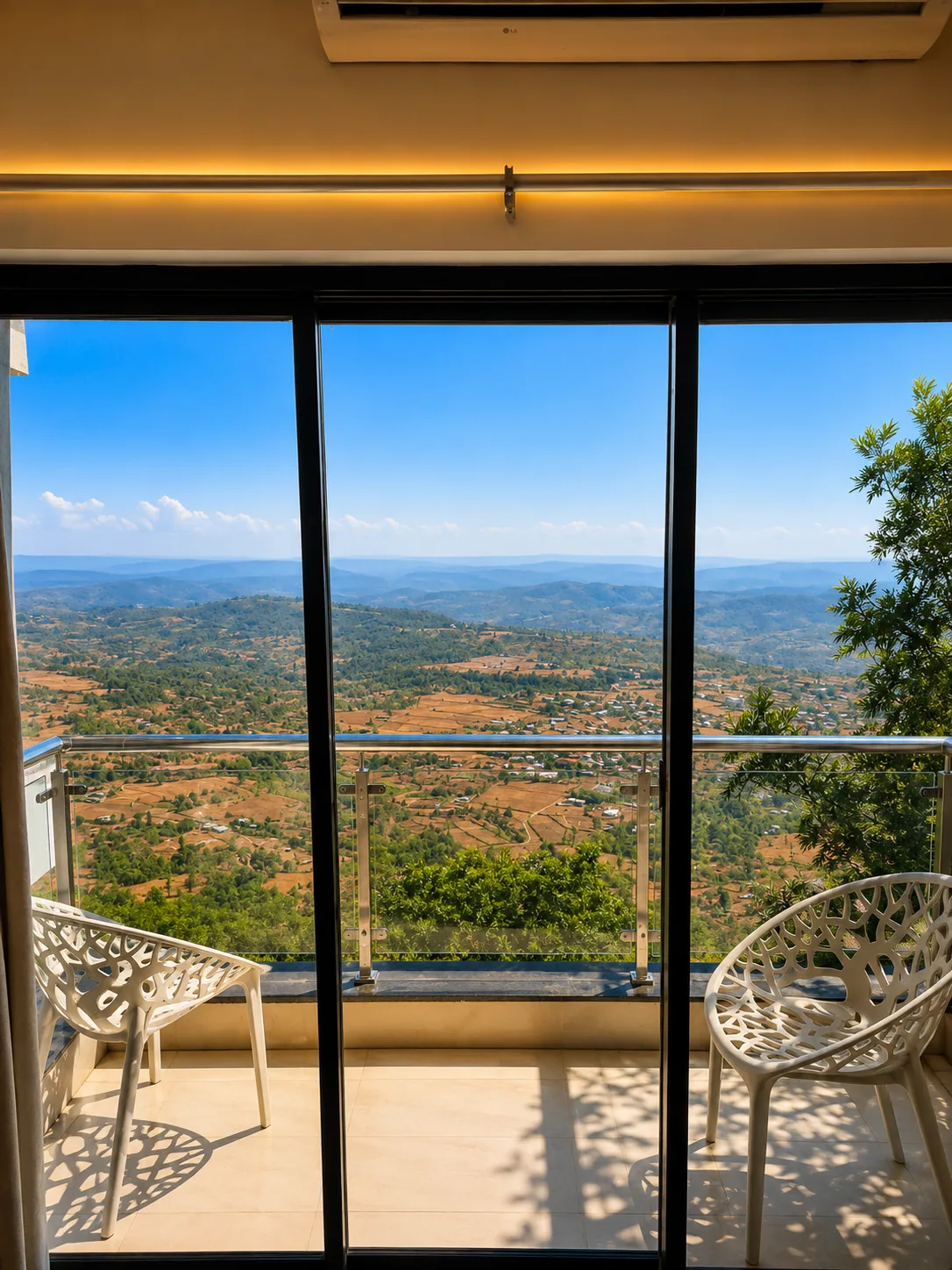 Valley view from a balcony chair at Toran Hill Resort